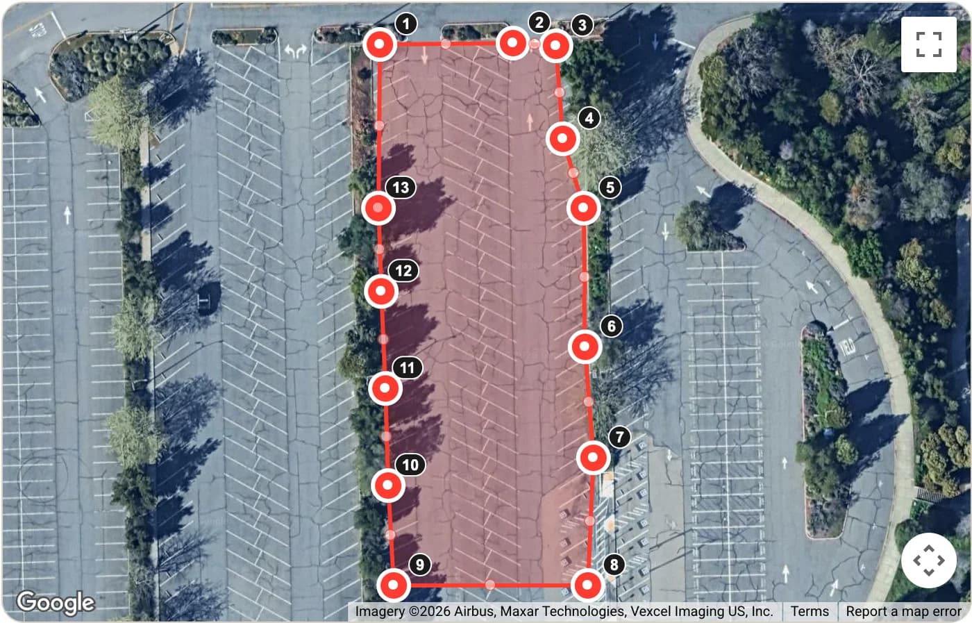 A satellite map of a parking lot with a red shaded outline drawn around the pavement and a numbered dot at each corner.