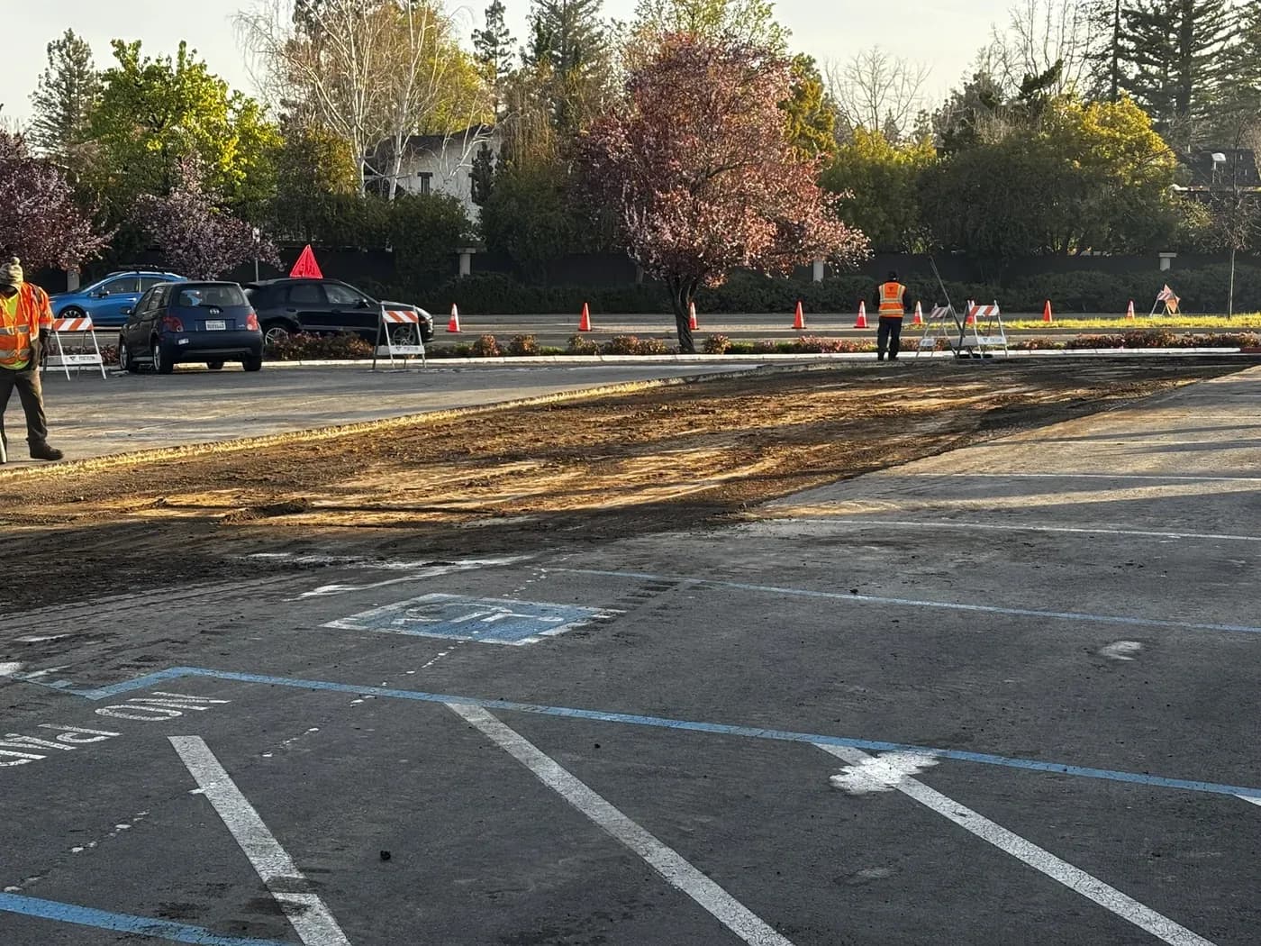 Accessible stalls and access aisles marked out on milled asphalt before the new surface is placed