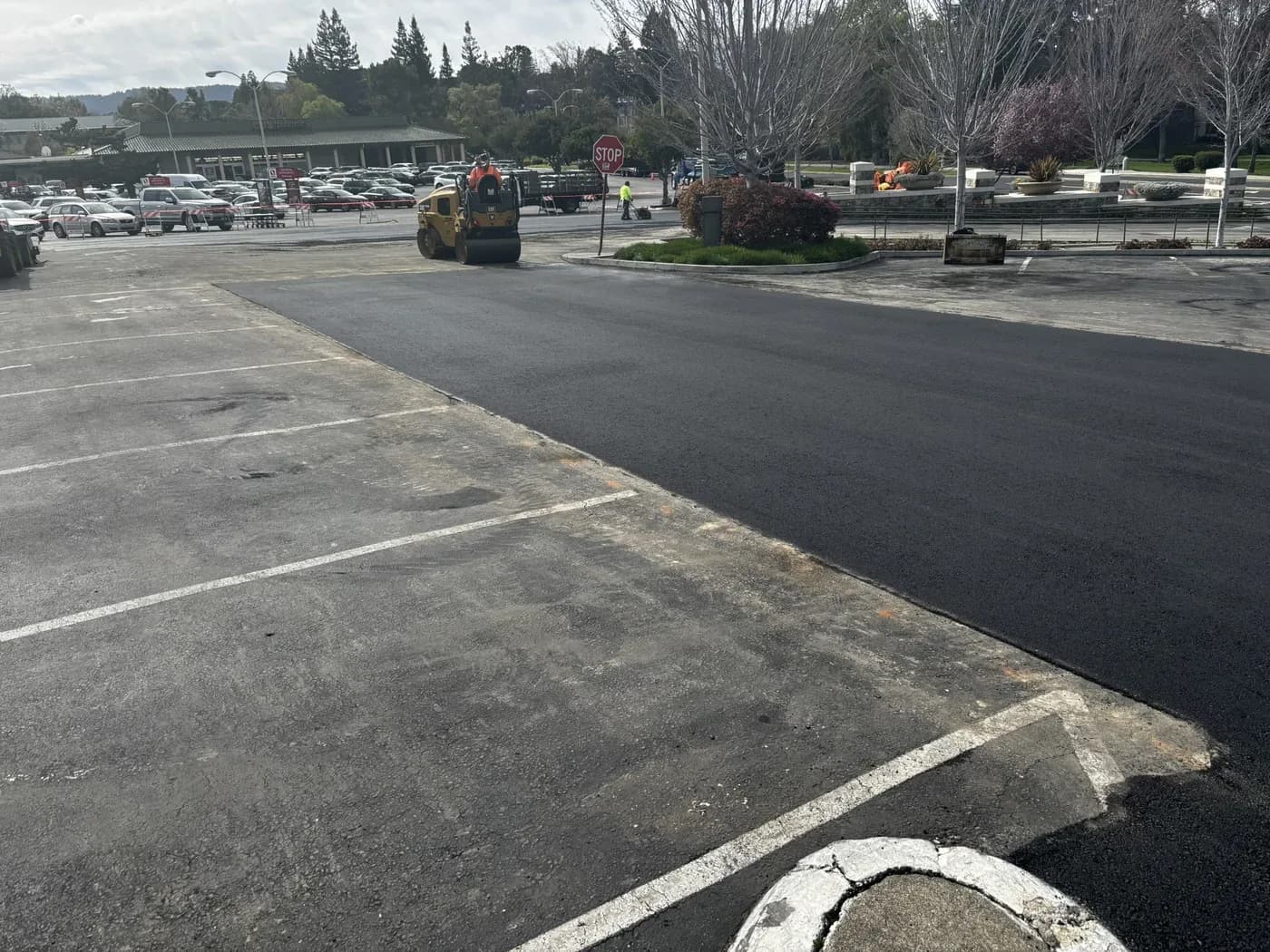 The edge where a new asphalt overlay meets the older parking lot surface it stopped at